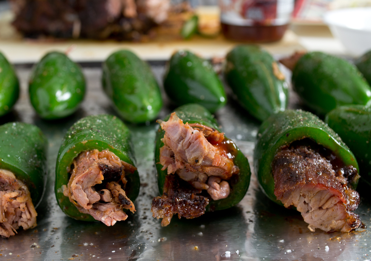 pork shoulder stuffed inside Jalapeño peppers on a sheet pan