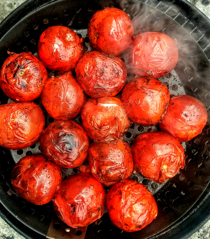 vine tomatoes being smoked on a charcoal grill