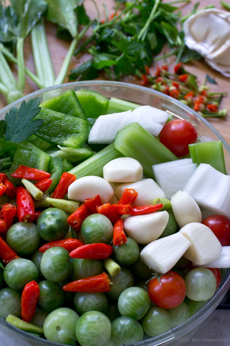 green tomato sofrito ingrediednts in a food processor