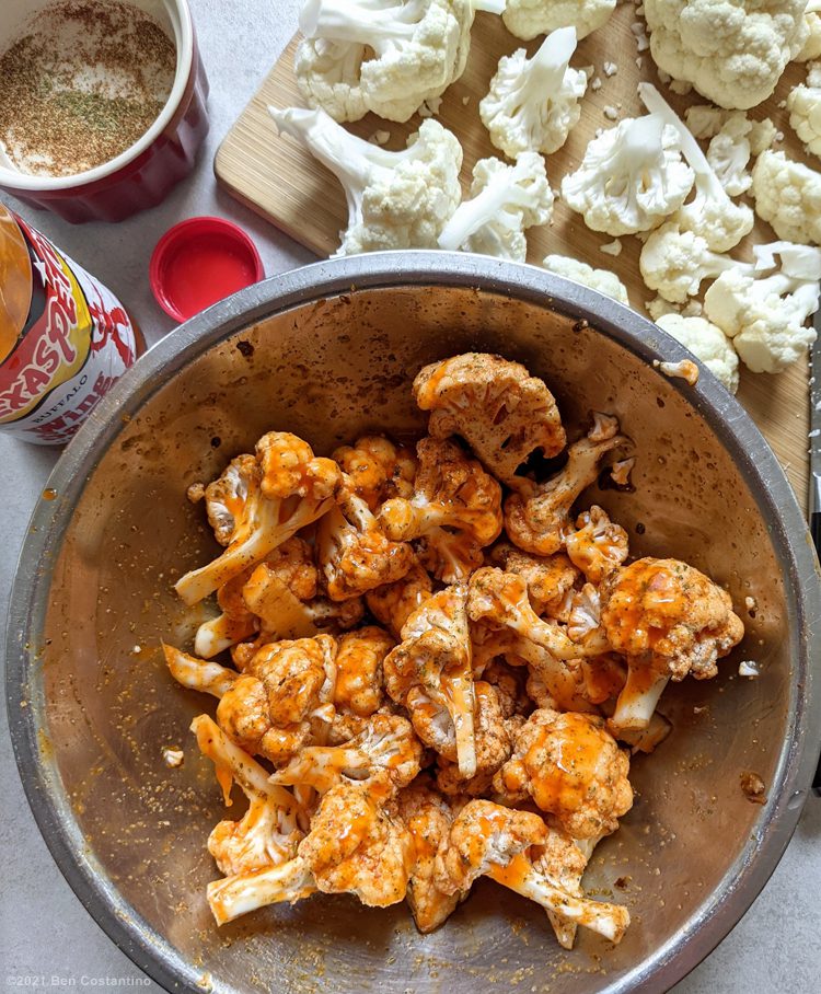 buffalo cauliflower being seasoned