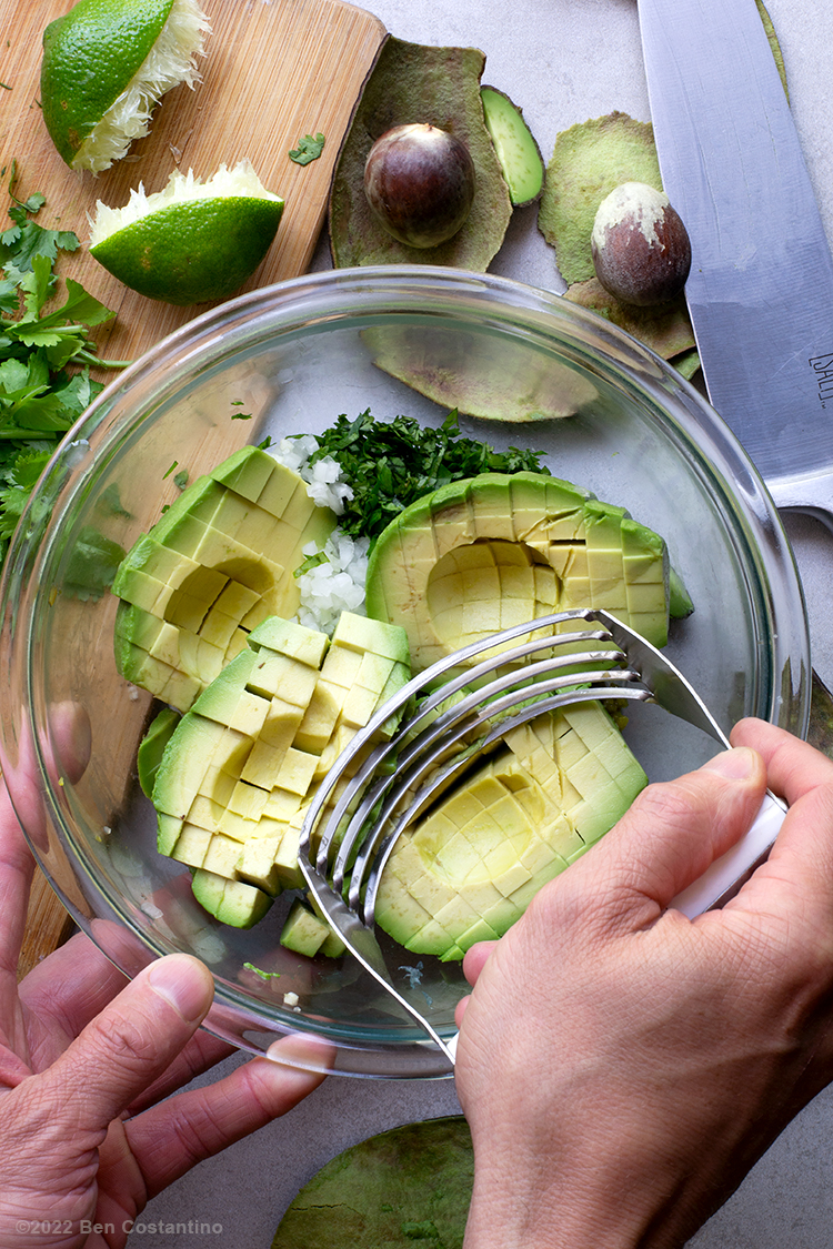 mashing guacamole with a pastry cutter
