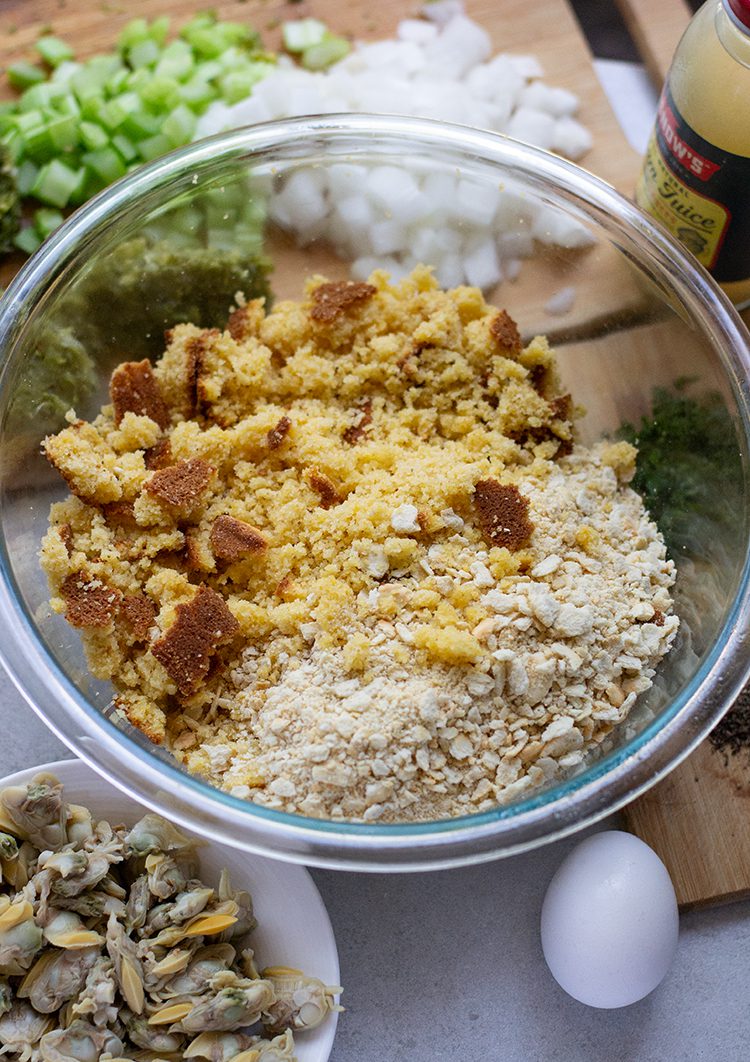 cornbread dressing ingredients in and around the bowl before they're mixed