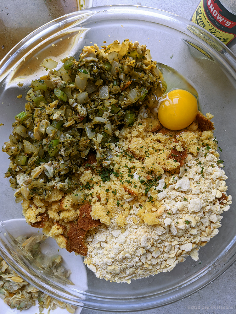 cornbread dressing ingredients in the bowl pre-mixed before the clam stock is added