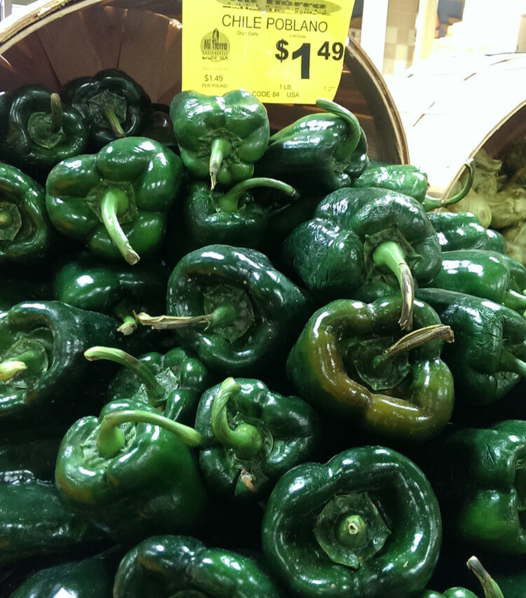 poblano peppers on display at the grocery store