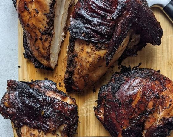 jerk chicken breasts and thighs cooked to completion on a cutting board
